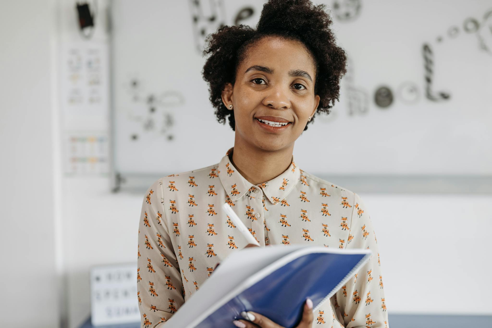 Confident Female Teacher Smiling While Holding A